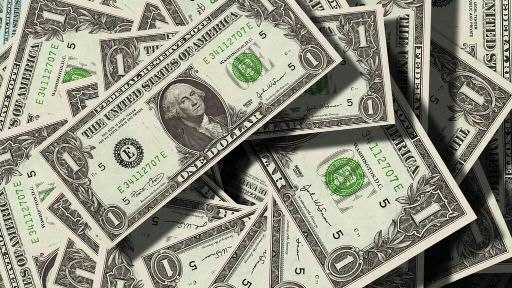 Close-up of scattered US dollar bills symbolizing finance and wealth.